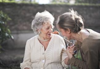 Elderly woman and younger woman having a conversation